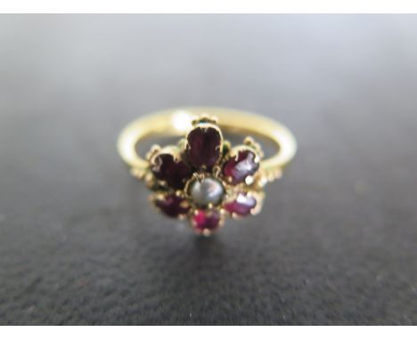 A 9ct Yellow Gold Garnet and Pearl Ring of flower head form, size M, approx 2.7 grams - light surface scratches and usage wea