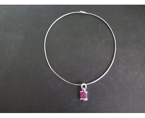 An 18ct white gold Ruby and Diamond pendant necklace - pendant 26mm x 12mm set with 16 small rubies - total weight approx 14 