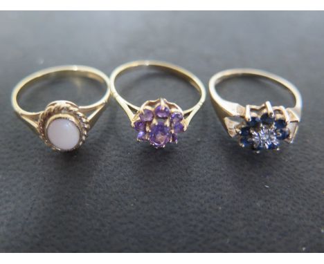 Three 9ct yellow gold dress rings, one with amethysts to shoulder, size P, one sapphire and diamond, size M, one with opal to