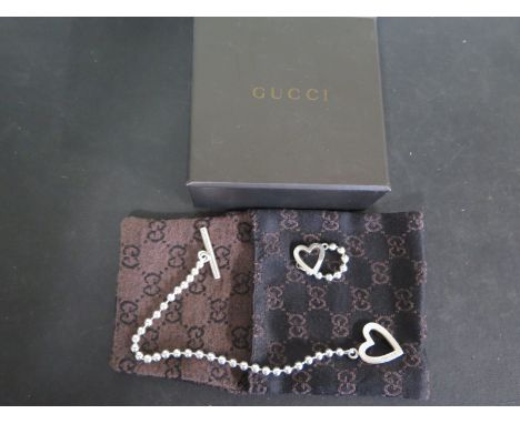 A Gucci silver love heart ring and bracelet in original packaging - both items in general good condition 