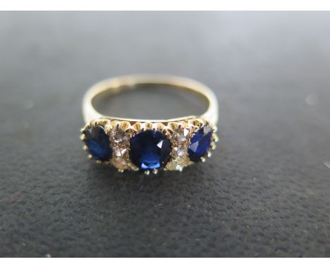 A yellow gold sapphire and diamond ring size P - approx weight 3.4 grams - central stone approx 5.5mm wide x 4.5mm - tests as