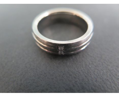 A Titanium and Diamond Ring, Size R-S, approx 3.8 grams, two small diamonds set to outer band - in fair condition with light 