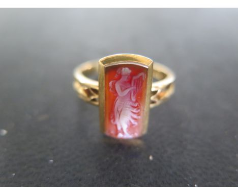 An 18ct Yellow Gold Ring with Figural Cameo in rectangular setting to shoulder, size 0, approx 3.7 grams - light surface scra