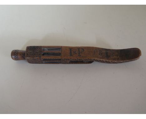 A good early 19th Century carved wooden knitting stick, carved and dated 1813 with initials I P and four rolling balls, 20cm 