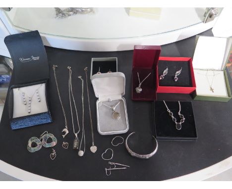 A collection of silver jewellery to include gate bracelets, heavy solid bangle, pendants and necklaces 