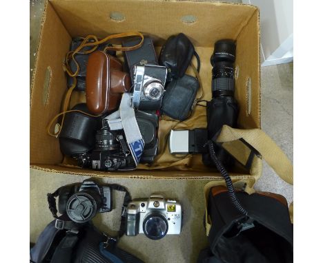 A box of vintage cameras and lenses including Minolta, Praktica and Russian 