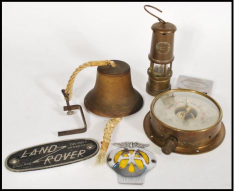 A collection of vintage 20th Century items, to include a barometer, hand held bell, AA car badge, Land Rover plaque, Miners l