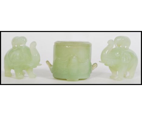 A group of three 20th century Chinese jade items to include a lidded pot and a pair of elephants with baby elephants standing
