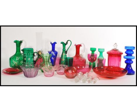 A selection of late 19th century / early 20th century coloured glass wares to include a cranberry glass oil lamp, glass jar w