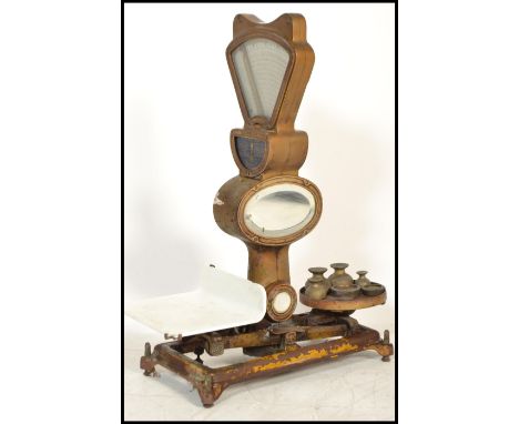 A large set of early to mid century Industrial shop enamel gilt metal and mirror glass grocers scales with central fan dial m