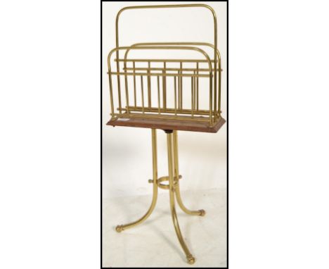 A 19th century Victorian brass and oak magazine stand&nbsp; raised on cylindrical tripod base with tubular dividing rack atop