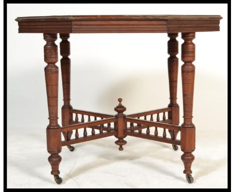 A 19th century Victorian mahogany centre table of octagonal form raised on turned octagonal legs having ceramic castors with 