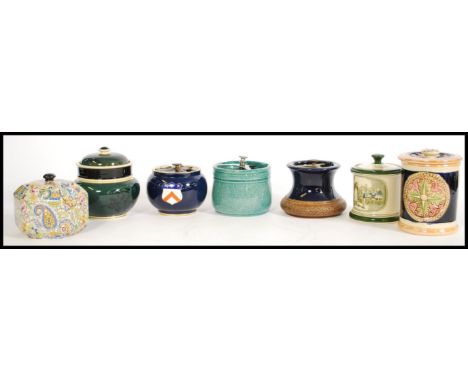 A collection of vintage tobacco jars to include a green and black jar with birds and florals to the sides, a tobacco jar with