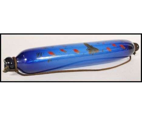 A 19th Century possibly Thomas Webb Bristol blue glass rolling pin, decorated with painted flowers and birds. Measures 33 cm 