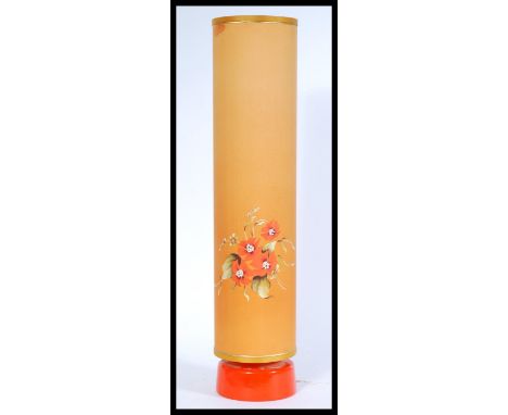 A vintage retro 1970's table lamp with a tall orange cylindrical shade having hand painted floral detailing and a circular la