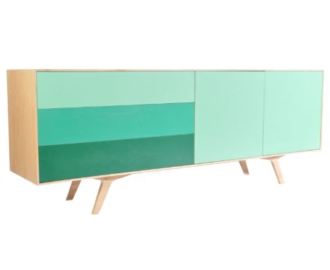 Live Iconic - A contemporary layered CNC machined wood sideboard credenza. The Sideboard having a bank of three drawer to one