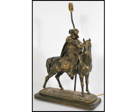 A large early 20th century spelter table lamp in the form of a horse and rider raised on naturalistic plinth base.&nbsp;Measu