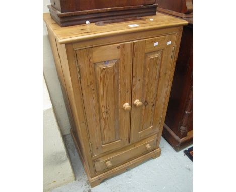 Modern pine two door, blind panelled cupboard with fitted drawer, on bracket feet.(B.P. 24% incl. VAT)