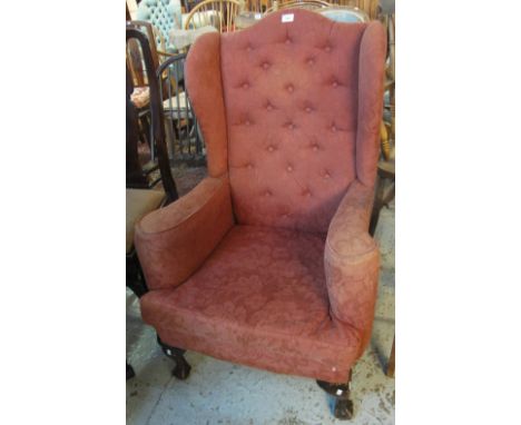 Early 20th Century upholstered button back wing armchair on cabriole legs and ball and claw feet.(B.P. 24% incl. VAT)