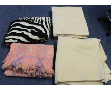 Three vintage woollen blankets, two plain cream blankets, both with guaranteed 'All Wool, Witney' labels and a pink geometric