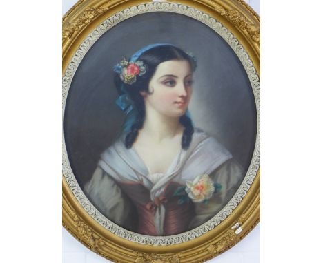 Half length pastel portrait of a young girl with a blue ribbon and flowers in her hair, under glass within an ornate oval fra