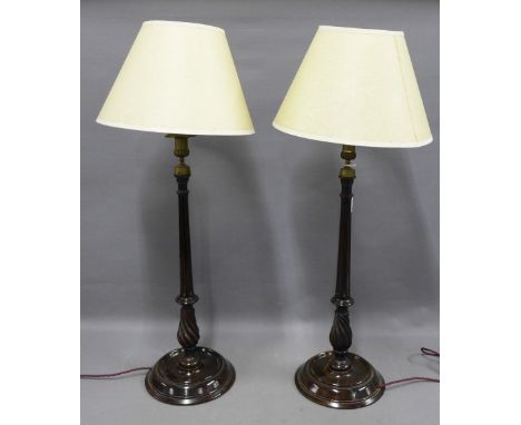 A pair of mahogany spiral twist column table lamps with brass caps and fittings, 55cm excluding fittings and shades (2) 