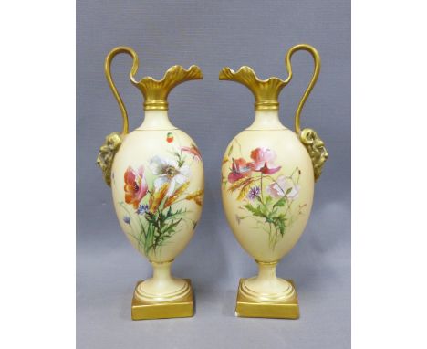 A pair of Royal Worcester ewers, blush ivory ground and with hand painted  flowers and gilded satyr mask head handles, shape 