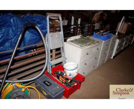 A large tray of hand tools; a small tool box; step ladder; and planter