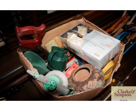 A box of gardening tools and pots etc.