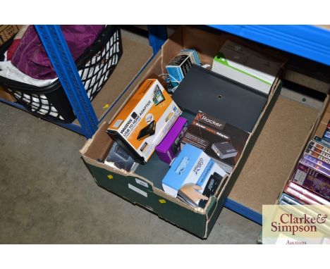 A box containing a HP Scanjet; an HDMI adaptor; a portable speaker etc