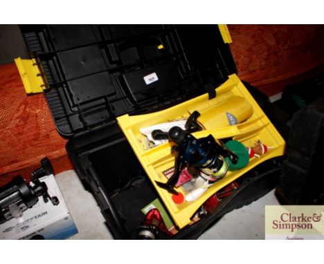 A tool box  containing various fishing equipment to include three reels and floats