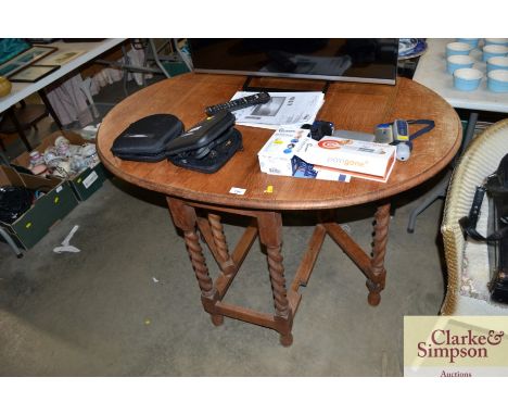 A light oak barley twist gate leg table