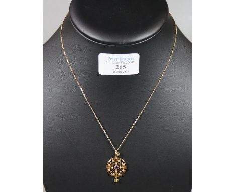 An amethyst, pearl and peridot, ‘Suffragette’ pendant set in 15ct gold on a 14ct gold chain. Approx weight 6.3 grams. (B.P. 2