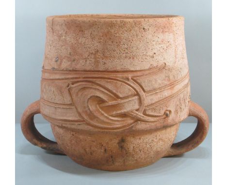 A Liberty &amp; Co terracotta baluster shaped planter with two loop handles, decorated with a continuous band of Celtic style