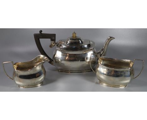 George VI Three piece silver tea service, to include: Teapot with ebonised handle, two handled sucrier and milk jug.  Chester