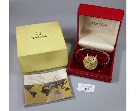 Omega gold plated gentleman's wristwatch with gilt face, sweep second hand and date aperture together with an associated expa
