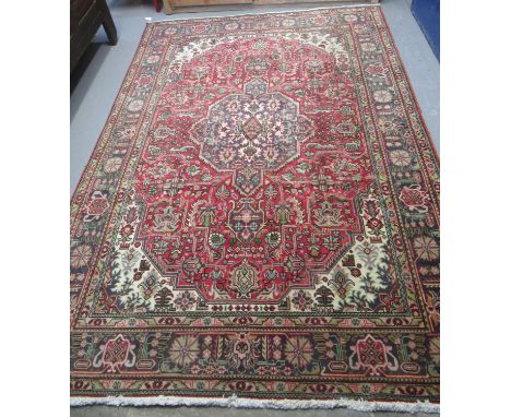 Middle Eastern design red ground multicoloured carpet having central medallion of flowers and foliage with flowerheads and ge