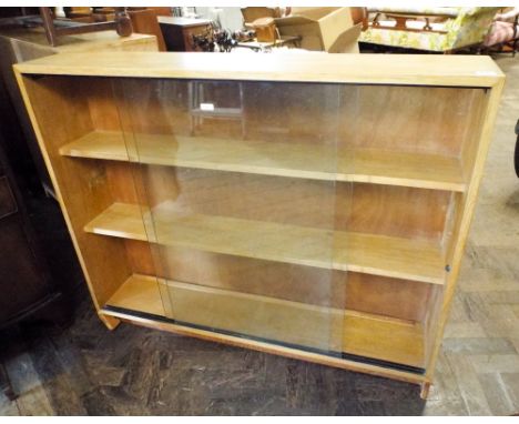 A light oak finished bookcase with sliding glass doors, 3'6 wide