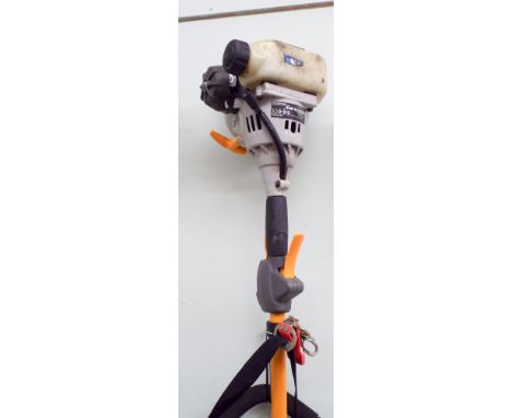 A Ryobi petrol engine strimmer with shoulder straps 