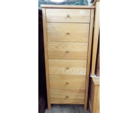 A light oak tallboy chest of six drawers 21" wide matching the previous lot 