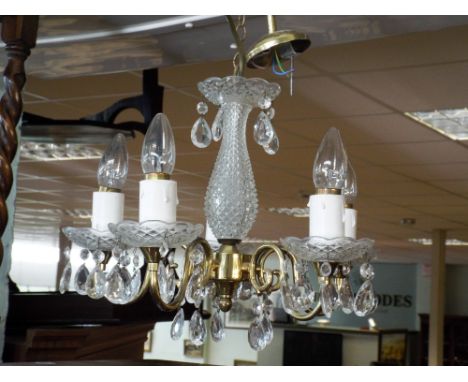 A five branch glass and brass chandelier, a hanging glass luster light shade and a pair on small glass luster style electric 