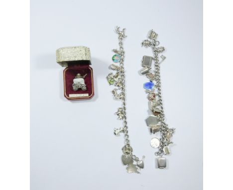 Two silver charm bracelets set with numerous charms and a silver vintage car shirt stud in box.
