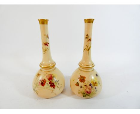 A pair of Royal Worcester blush ivory, narrow necked, bud vases painted with flowers, number underneath 1528, height 18cm    