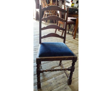 A set of four oak ladder back dining chairs on turned legs 