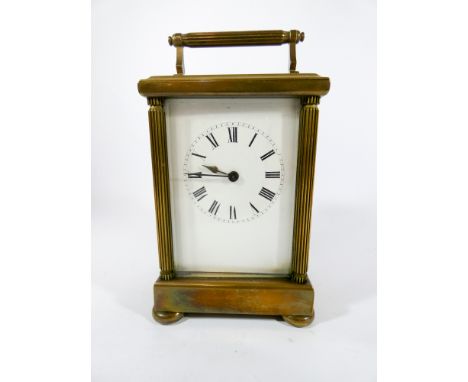 A French brass carriage clock with reeded pilasters to the corners height 20cms to top of carrying handle, complete with key 