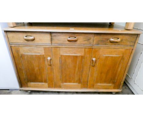 An Ercol light oak sideboard fitted three drawers and three cupboards, 3' wide 