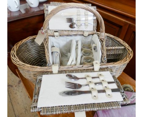 A wicker picnic hamper with all fittings in new condition 