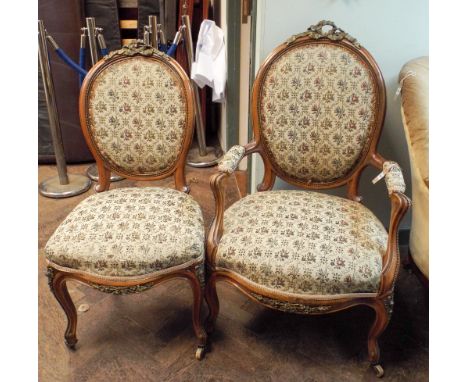 Pair of French walnut and gilt metal mounted arm chairs, one with arms the other without, upholstered in floral tapestry, lat
