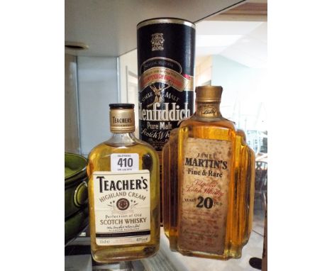 A bottle of Glenfiddich malt whisk, a bottle of James Martins scotch blended whisky and a half bottle of Teachers highland cr