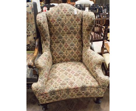 A Georgian style tapestry upholstered wing backed Easy Chair 